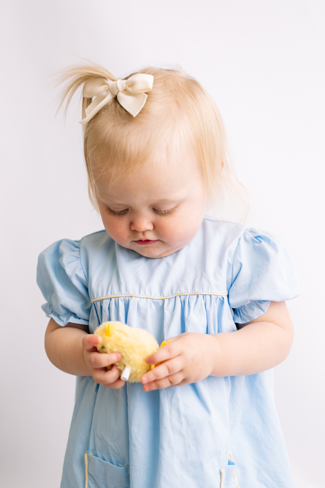 toddler heirloom portrait with a toy